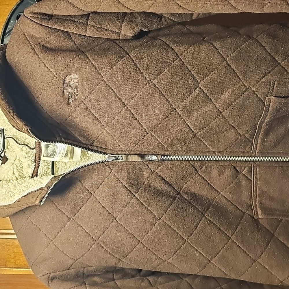 The NorthFace sweater jacket with hood brown size Medium.